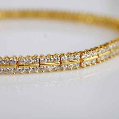 Lot 2043 - A yellow metal tennis bracelet set with 216...