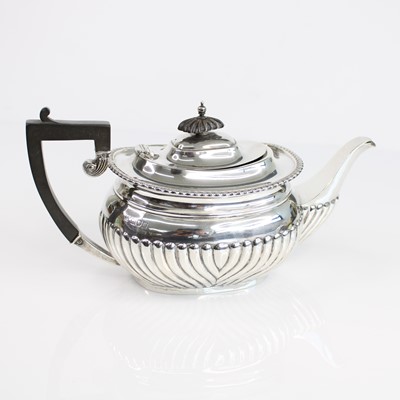 Lot 69 - An Edwardian silver teapot, of half reeded...