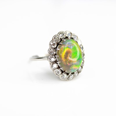 Lot 2073 - A white metal opal and diamond oval cluster...