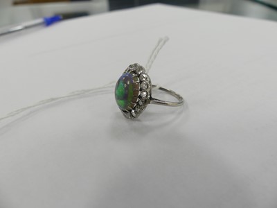 Lot 2073 - A white metal opal and diamond oval cluster...