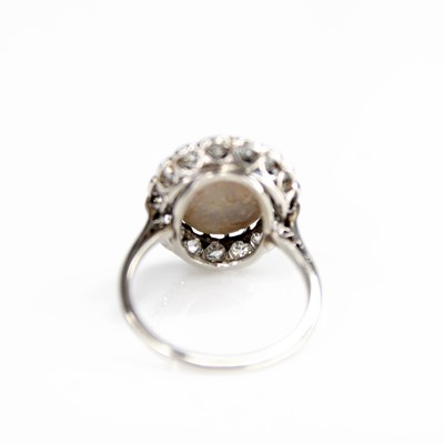 Lot 2073 - A white metal opal and diamond oval cluster...