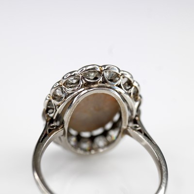 Lot 2073 - A white metal opal and diamond oval cluster...