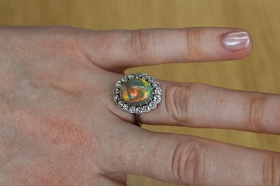 Lot 2073 - A white metal opal and diamond oval cluster...