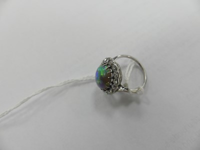 Lot 2073 - A white metal opal and diamond oval cluster...