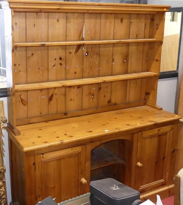 Lot 561 - A rustic pine kitchen dresser, having two-tier...