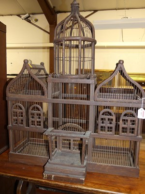 Lot 663 - A rustic stained and wired metal birdcage, in...