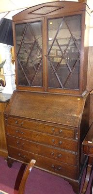 Lot 666 - A George III oak slopefront four-drawer...