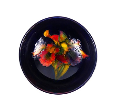 Lot 157 - A Moorcroft Blue Flambé Orchid pattern pottery...