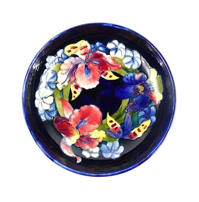 Lot 153 - A Moorcroft Iris Orchid pattern pottery footed...