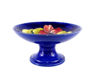 Lot 167 - A Moorcroft Hibiscus pattern pottery footed...