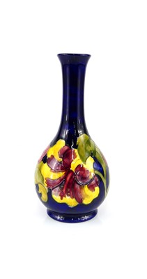 Lot 187 - A Moorcroft Hibiscus pattern pottery bottle...