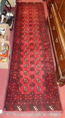 Lot 739 - A Persian woollen red ground Bokhara hall...