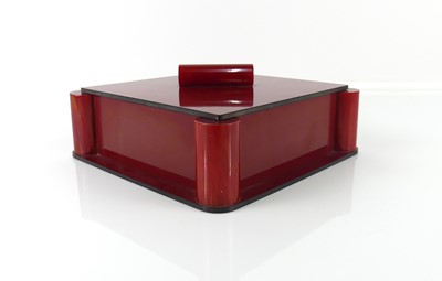 Lot 340 - An Art Deco rouge bakelite square table box...