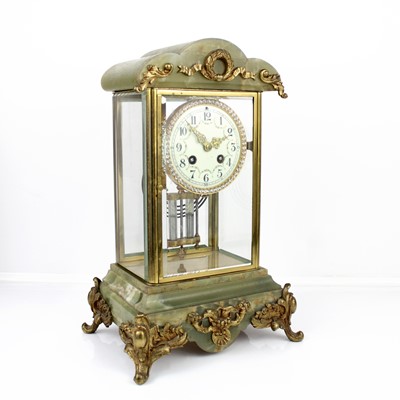 Lot 281 - An early 20th century gilt brass and onyx...