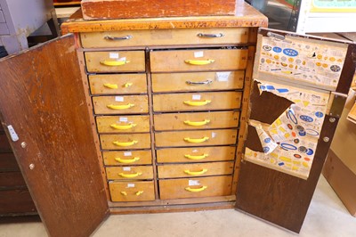 Lot 115 - A 1920s oak multi-drawer cabinet containing a...
