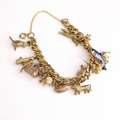 Lot 138 - A yellow metal filed curblink charm bracelet,...