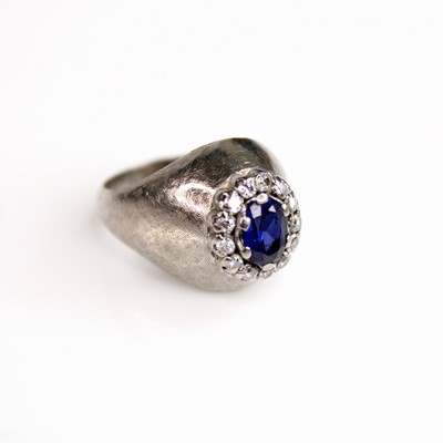 Lot 114 - A white metal, sapphire and diamond oval...