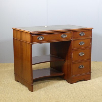 Lot 653 - A contemporary mahogany kneehole writing desk...