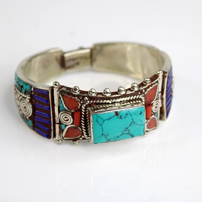 Lot 293 - A white metal and hardstone set Tibetan cuff...