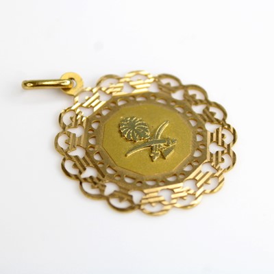 Lot 251 - A yellow metal disc pendant with centre panel...