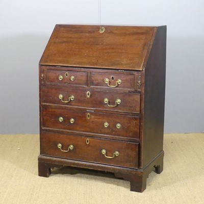 Lot 647 - A George III mahogany compact slopefront...