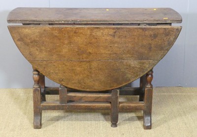 Lot 660 - An 18th century provincial joined oak dropleaf...