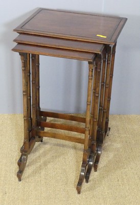 Lot 658 - A mahogany nest of three occasional tables,...