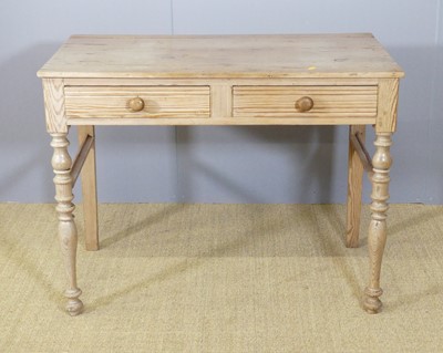 Lot 679 - An Edwardian pine two drawer side table, on...