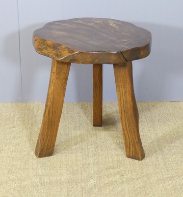 Lot 627 - A chunky stained elm shaped top occasional...