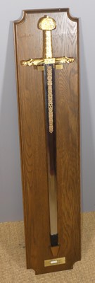 Lot 616 - A boxed ceremonial sword with oak backboard