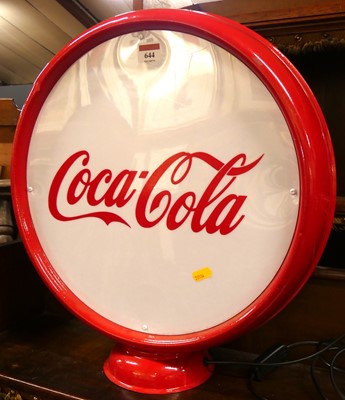 Lot 644 - A red painted metal and perspex inset circular...