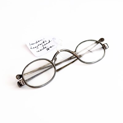 Lot 247 - A pair of George III silver wig spectacles, in...