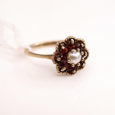 Lot 267 - A 9ct gold, garnet and seed pearl set flower...