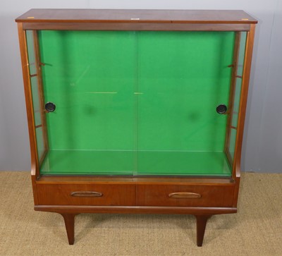 Lot 688 - A 1970s teak display cabinet, having twin...