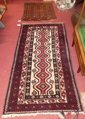 Lot 735 - A Persian woollen Balouch rug, having a cream...