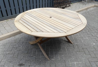 Lot 762 - A teak circular outdoor dining table, dia.149cm