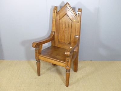 Lot 698 - A joined oak Gothic style scroll open armchair,...