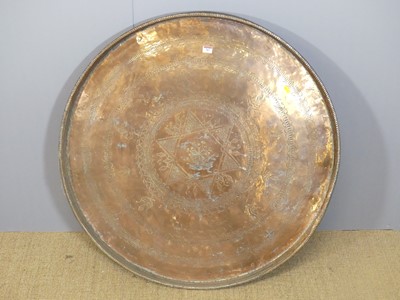 Lot 707 - A large Eastern floral engraved brass circular...