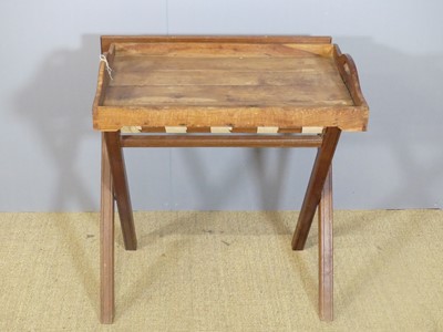 Lot 717 - A hardwood butler's tray table on X-framed...