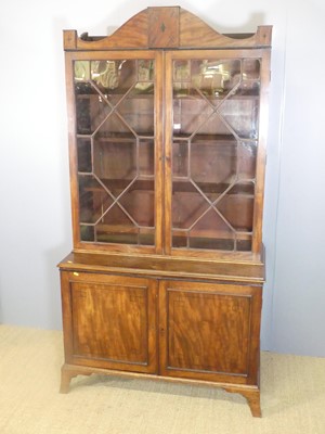 Lot 724 - A Regency mahogany bookcase cupboard, the twin...