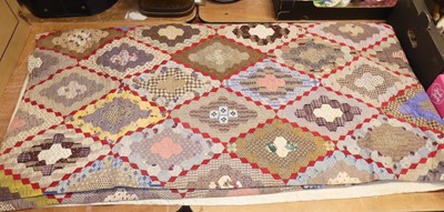 Lot 126 - An early 20th century patchwork quilt,...