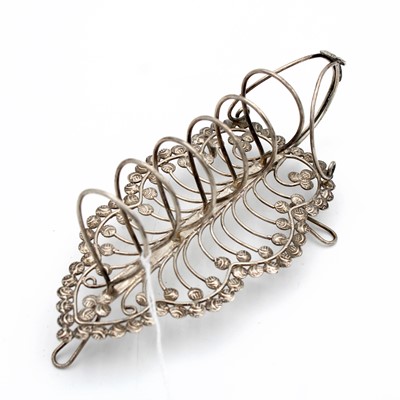 Lot 173 - A white metal stylised toast rack, the base of...