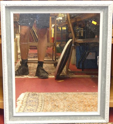 Lot 556 - A wooden framed and bevelled oval wall mirror;...