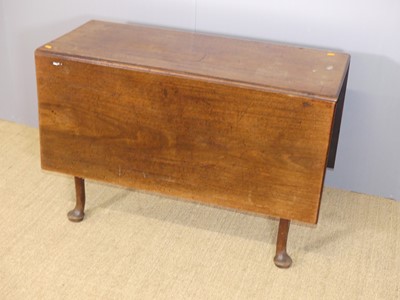Lot 632 - A George III mahogany drop leaf dining table,...