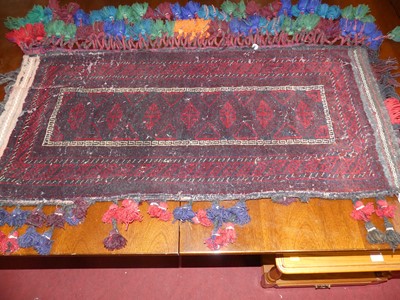 Lot 750 - An Afghan red ground woollen Belouch tribal...