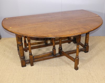 Lot 682 - A joined oak double gateleg dining table, with...