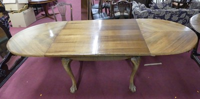 Lot 677 - A 1930s walnut extending dining table, the...