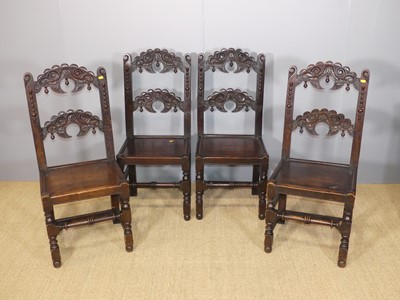 Lot 687 - A set of four joined and floral relief carved...