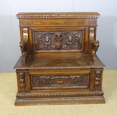 Lot 708 - A walnut raised and relief carved box seat...