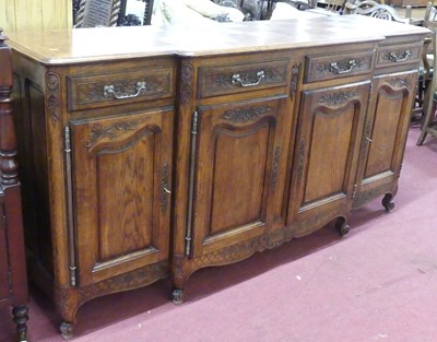 Lot 712 - A large French provincial oak breakfront...